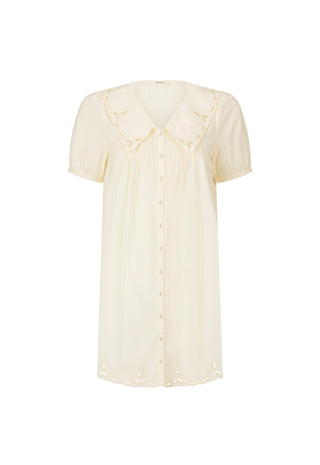 a-short-sleeve-cream-colored-blouse-with-a-peter-pan-collar-featuring-delicate-eyelet-embroidery-along-the-collar-and-hem-and-a-button-down-front